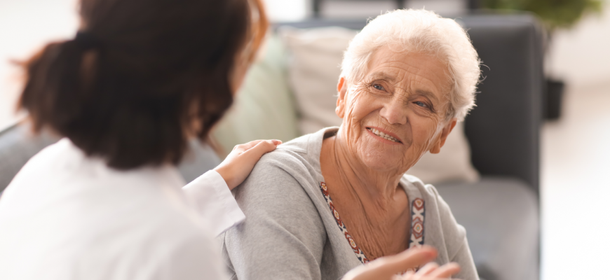 A doctor speaking with a senior resident at a NY nursing home.