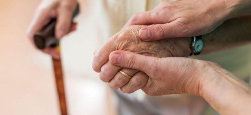 person holding cane being assisted