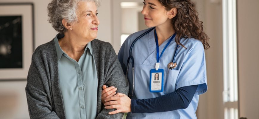 Elderly women being assisted by a nurse