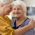 Lady hugging her elderly mother.
